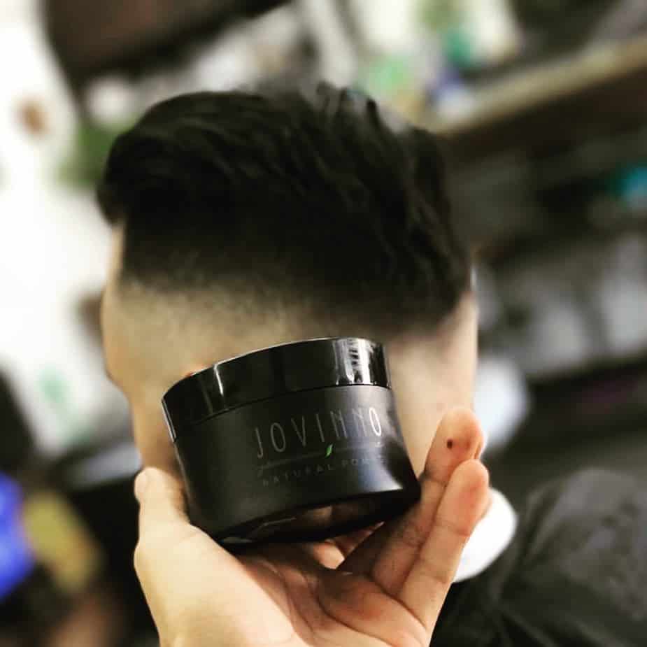 holding a jovinno natural pomade