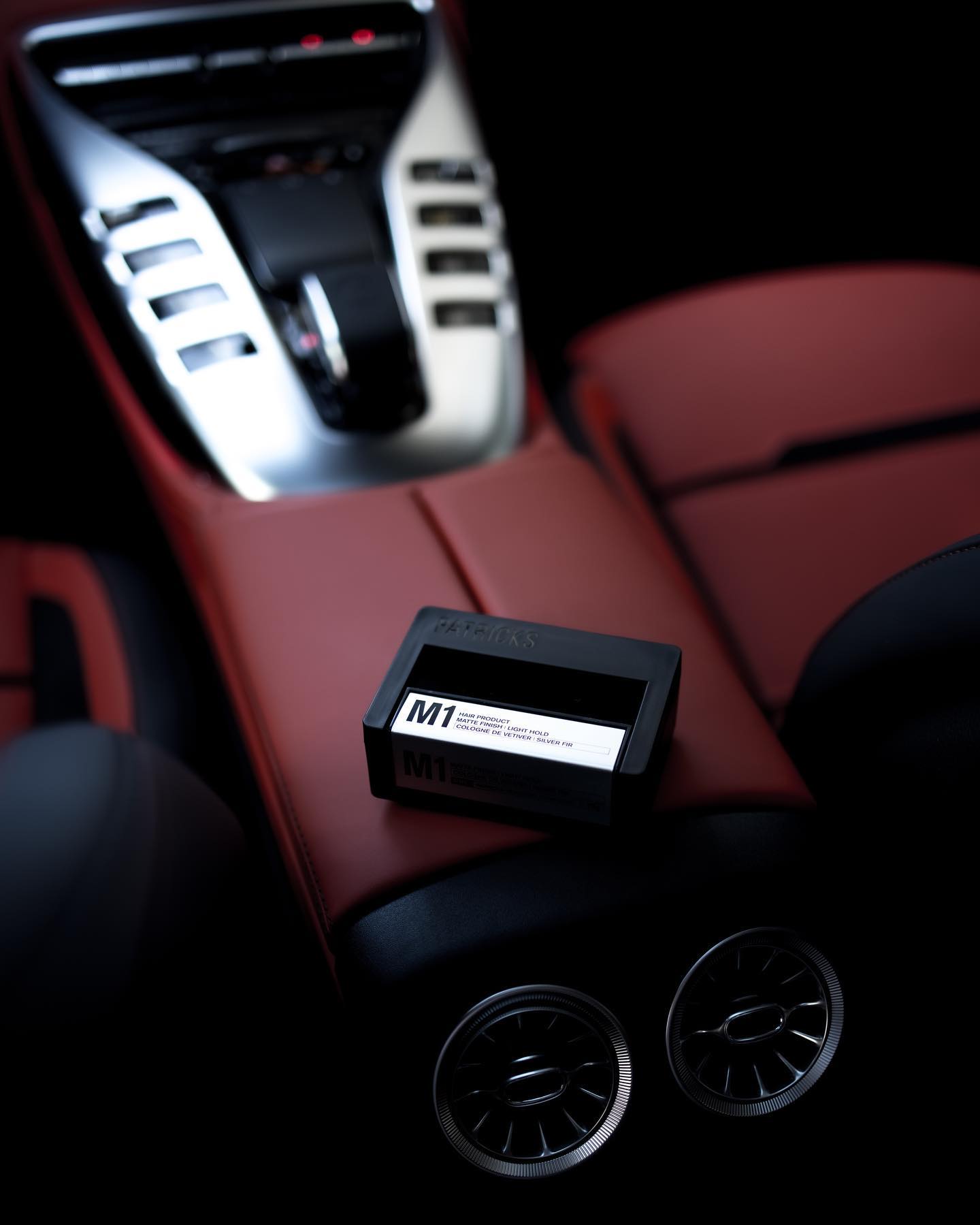 an m1 pomade on top of a cars center console