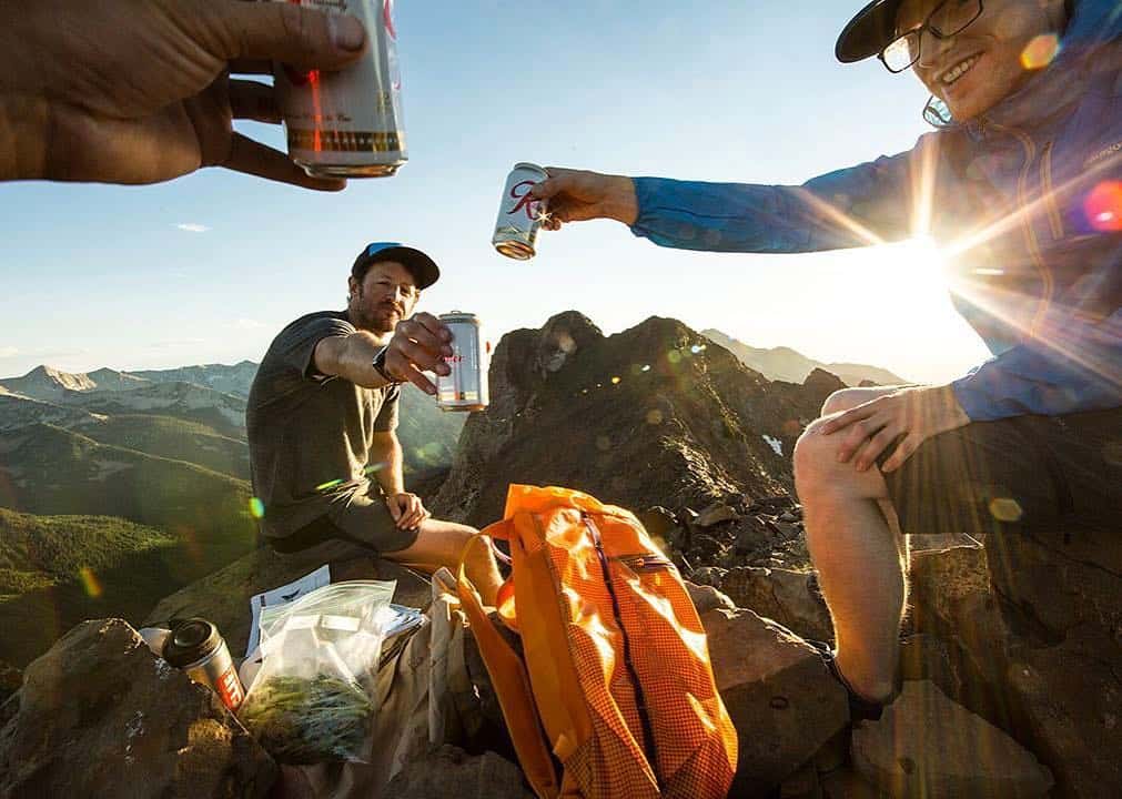Men having drinks on top of a mountain