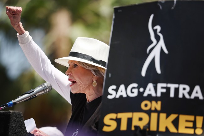 LOS ANGELES, CALIFORNIA - JULY 28: Jane Fonda speaks to the crowd as Starbucks workers stand on the picket line with striking SAG-AFTRA and Writers Guild of America (WGA) members in solidarity outside Netflix studios on July 28, 2023 in Los Angeles, California. The show of support is part of a Starbucks Workers United ‘The Union is Calling’ summer bus tour across 13 cities in an effort to unionize more Starbucks stores with workers calling for a living wage and other protections amid a so-called ‘hot labor summer’. (Photo by Mario Tama/Getty Images)