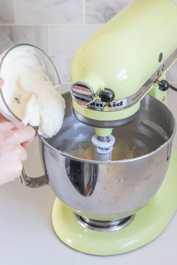 Adding half of sour cream mixture to the mixing bowl.
