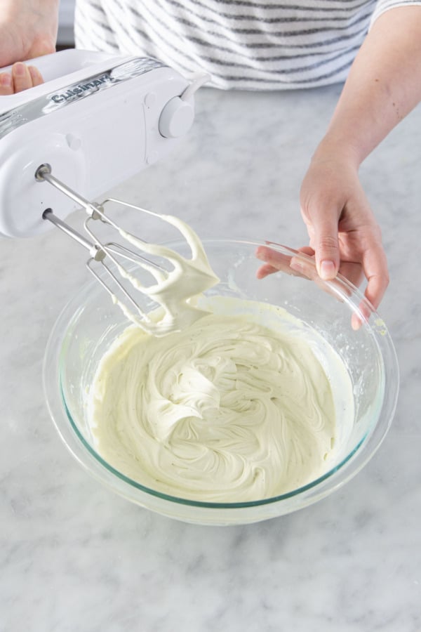 Whipped ganache holding soft peaks that indicates it is done.