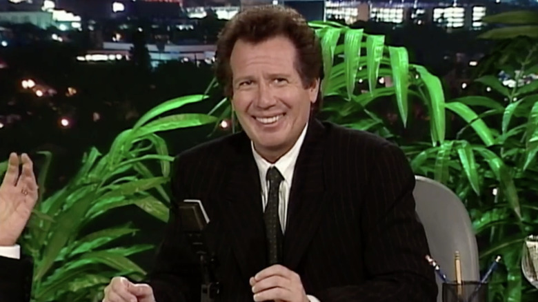 Garry Shandling as Larry Sanders smiling nervously in The Larry Sanders Show