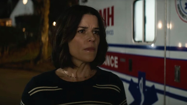 Neve Campbell as Sidney Prescott standing by an ambulance in Scream 7