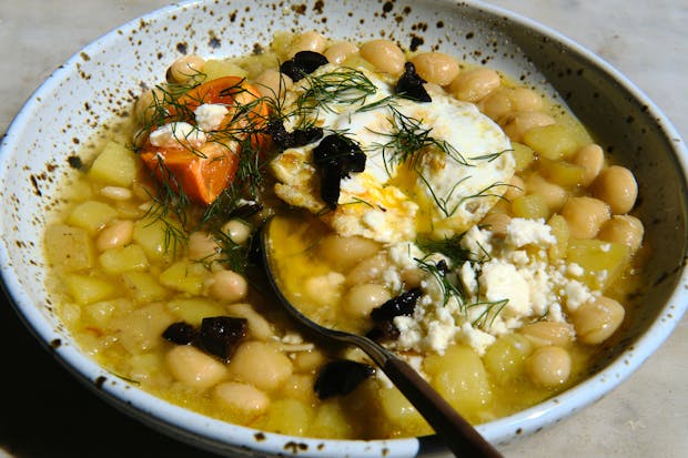 white bean soup in a bowl topped with feta cheese