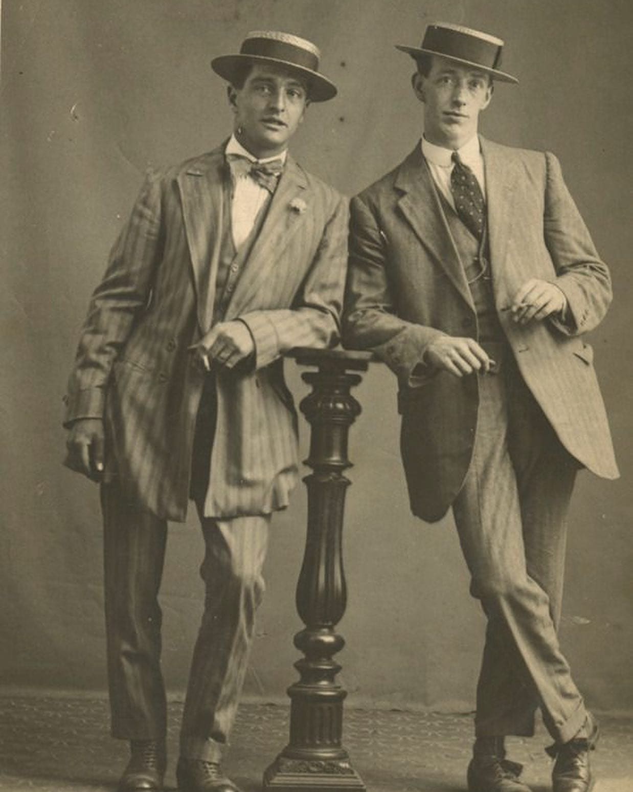 two men in 1920s wearing hats and three piece suits