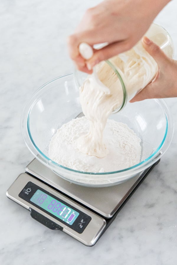 Weighing out 100 grams of mature sourdough starter discard.