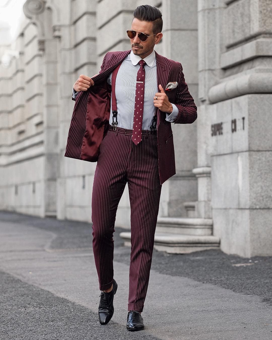 man in a suit with suspenders