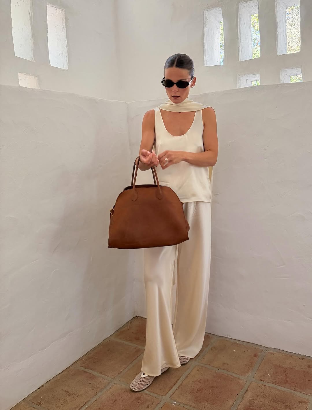 An image of a woman wearing white flats, shoe trend for spring 2026.