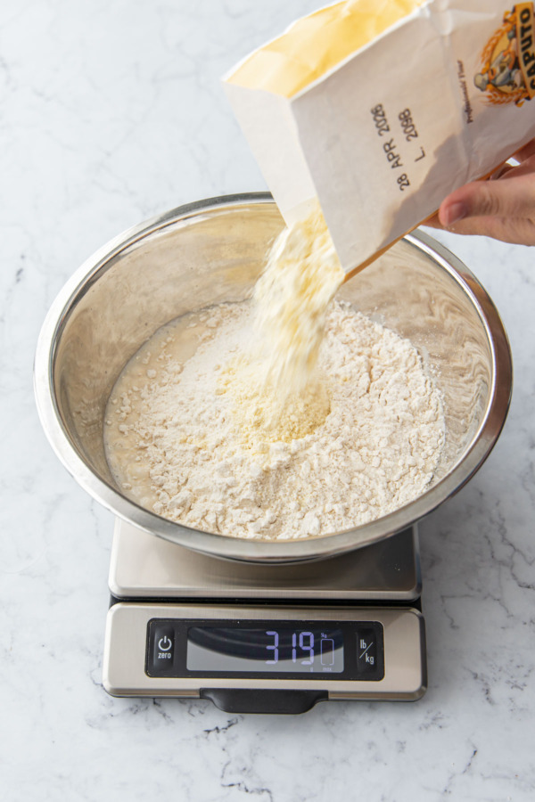 Adding semolina flour to the focaccia mixture.