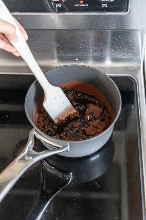Melting butter with cocoa powder in a small saucepan.