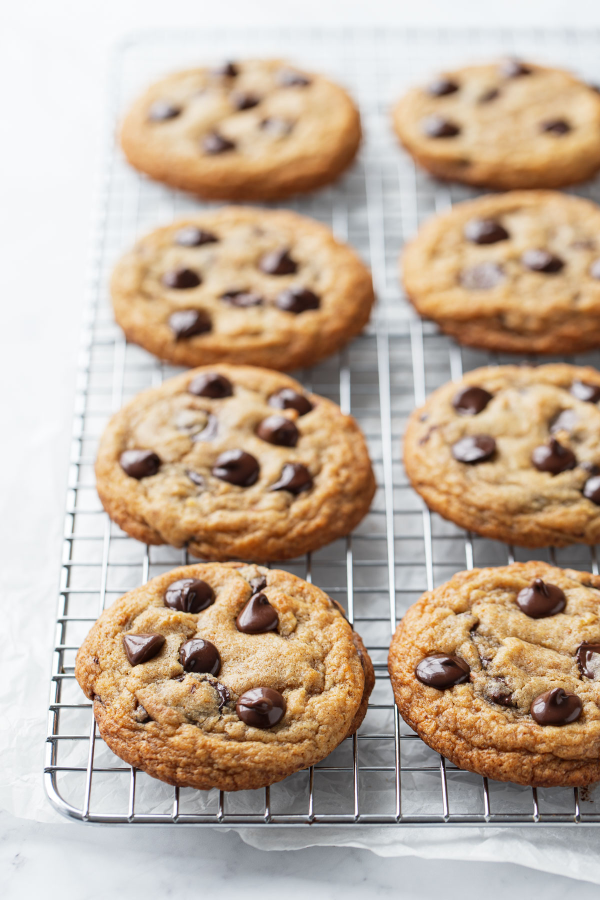 Rows of Brown Butter Banana Bread Chocolate Chip Cookies on a silver baking rack.