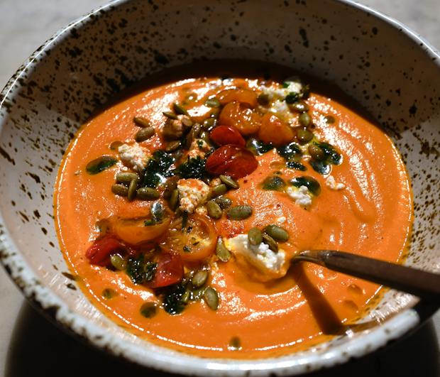butternut squash soup with red lentils and toppings in a bowl