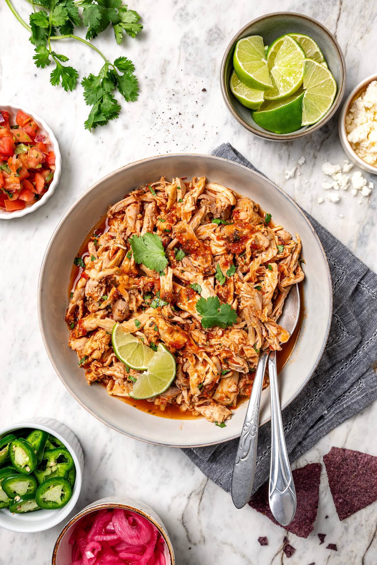 Overhead view of crockpot salsa chicken served in a large bowl.