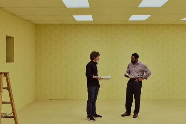 Two men stand in a yellow, empty room with fluorescent ceiling lights, evoking the Backrooms aesthetic.
