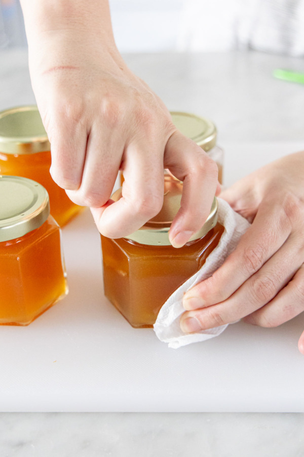 Securing lids onto filled jelly jars.
