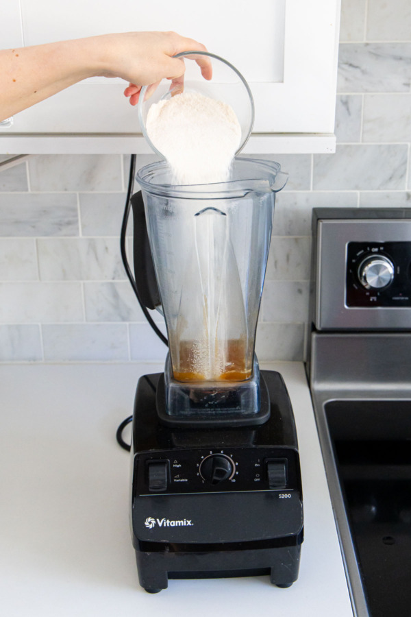 Pouring sugar-pectin mixture into a blender along with hot cider.